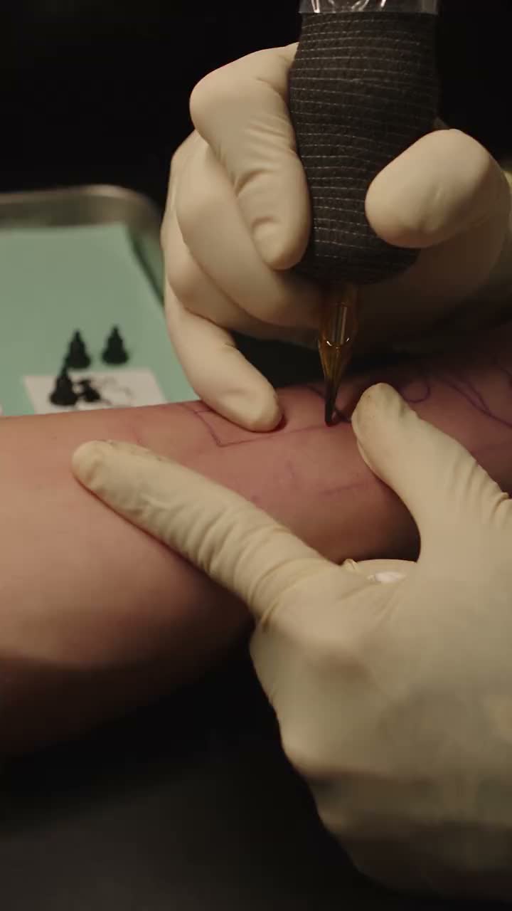 An artist working on a fresh piece, filmed over the shoulder